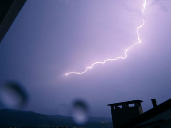 Lightning strike against cloudy sky