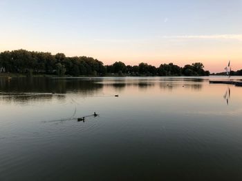 Scenic view of lake against sky during sunset