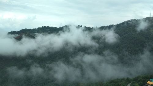 Scenic view of waterfall against sky