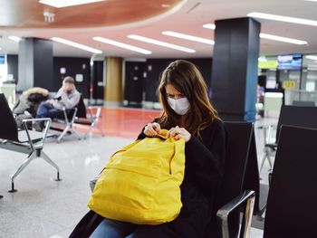 Woman sitting on seat in cafe