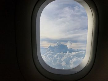 Cloudy sky seen through airplane window