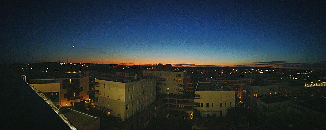 building exterior, architecture, built structure, illuminated, city, cityscape, night, high angle view, copy space, residential district, clear sky, residential structure, residential building, sky, crowded, dusk, blue, city life, outdoors, house