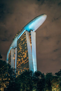 Low angle view of illuminated built structure against blue sky