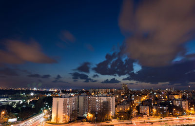 Illuminated cityscape against sky at night