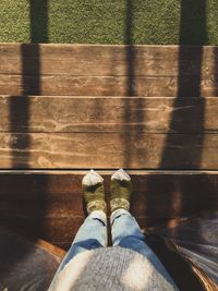 Low section of woman standing on hardwood floor