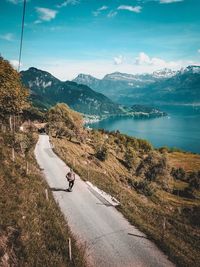 High angle view of man skateboarding on road by river