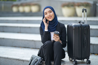 Full length of woman using mobile phone