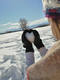 Boy on snowy field against sky