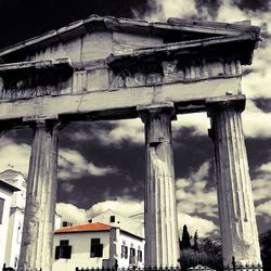 Low angle view of building against cloudy sky