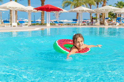 Portrait of woman swimming in pool