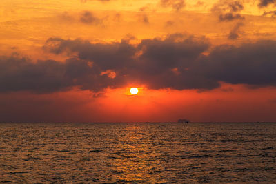 Scenic view of sea against romantic sky at sunset