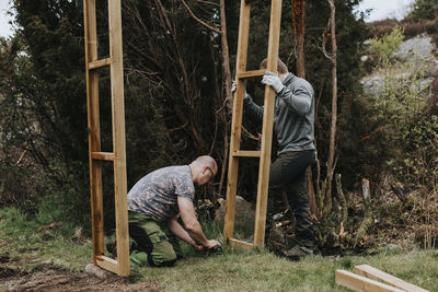 Men putting wooden frame up