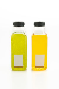 Close-up of yellow bottle against white background