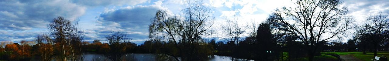 Scenic view of river against cloudy sky