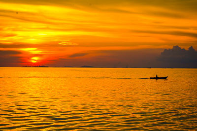 Scenic view of sea against orange sky