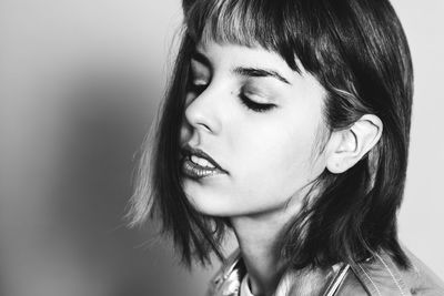 Close-up of beautiful young woman over white background