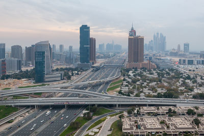 High angle view of road amidst buildings in city against sky