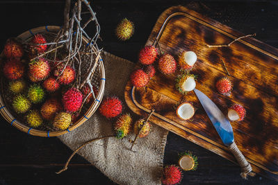 Directly above shot of rambutans and cutting board on table