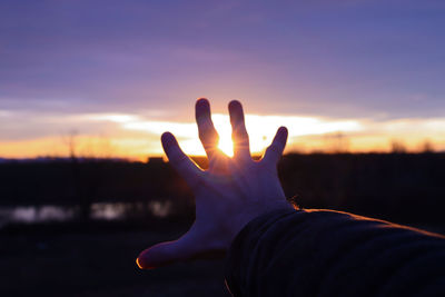 Midsection of silhouette person against sky during sunset