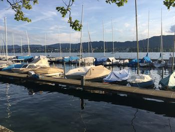 Boats moored in lake against sky