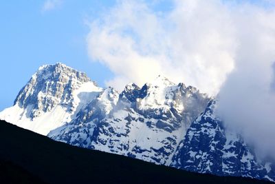 Scenic view of snow covered mountains against sky