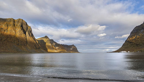 View from the beach on large mountains in a fjork at skaland in the senja island in norway