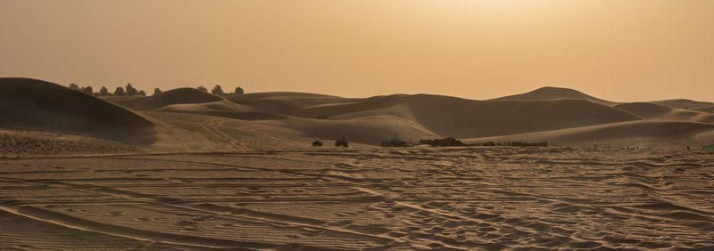 Scenic view of desert against sky during sunset