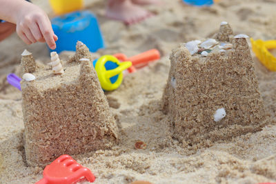 Close-up of hands on sand