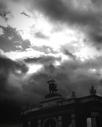 Low angle view of statue against cloudy sky