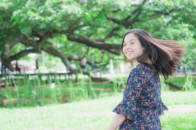 Side view of a smiling young woman