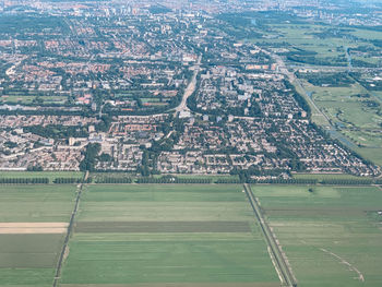 High angle view of field and buildings in city