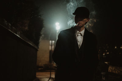 Man standing in illuminated city at night