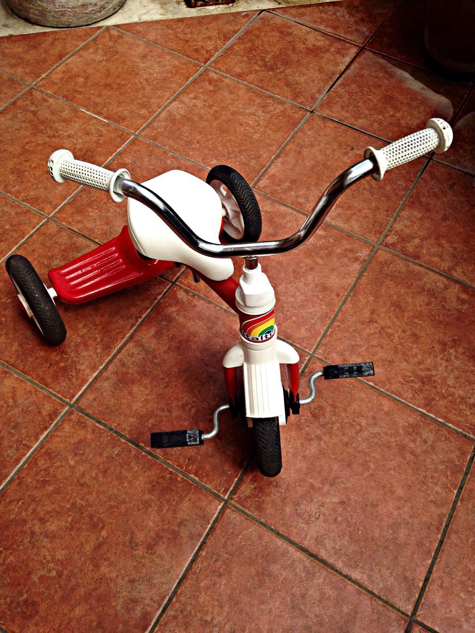 high angle view, sport, bicycle, still life, childhood, equipment, technology, indoors, skill, skateboard, shadow, toy, day, music, hobbies, competition, safety