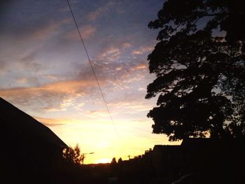 Low angle view of built structure against sky at sunset