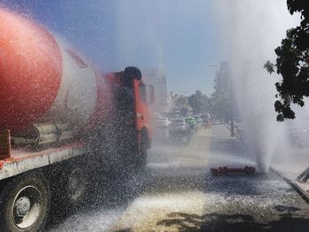 Truck on road by fountain