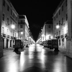 Illuminated street lights in city at night