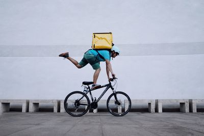 Man riding bicycle on road