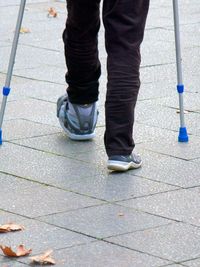 Low section of man standing on sidewalk