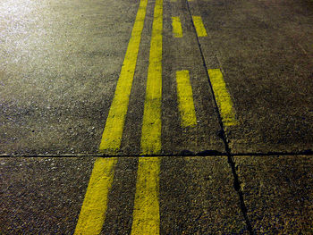 High angle view of yellow sign on road