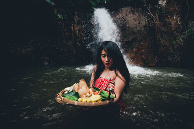 Young woman sitting in water