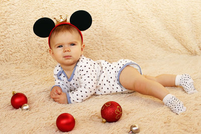 High angle view of girl by decoration on carpet