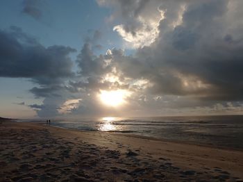 Scenic view of beach against sky during sunset