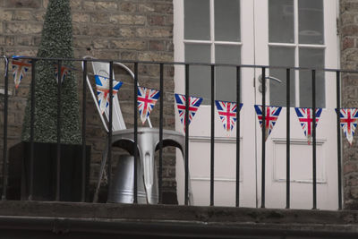 Low angle view of flag against built structure