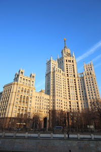 Low angle view of buildings against blue sky