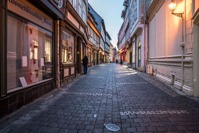 Empty alley amidst buildings in city