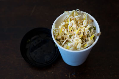 Bean sprouts, mung bean and taugeh growing in a recycled coffee cup. often used in asian dishes