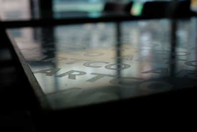 High angle view of text on glass table