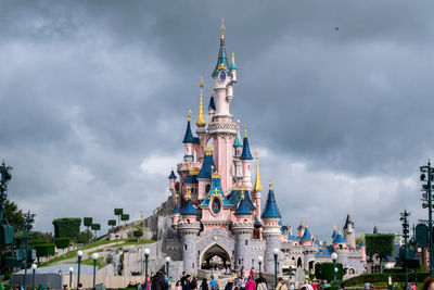 Low angle view of buildings against cloudy sky