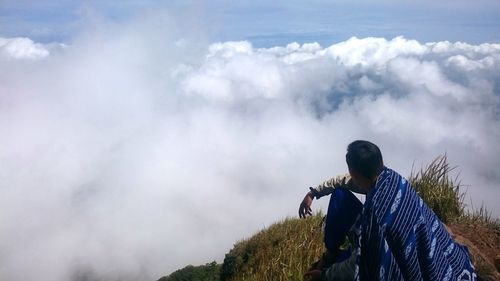 Man looking at cloudy sky