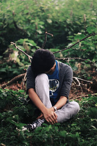 View of person in woods hiding their face